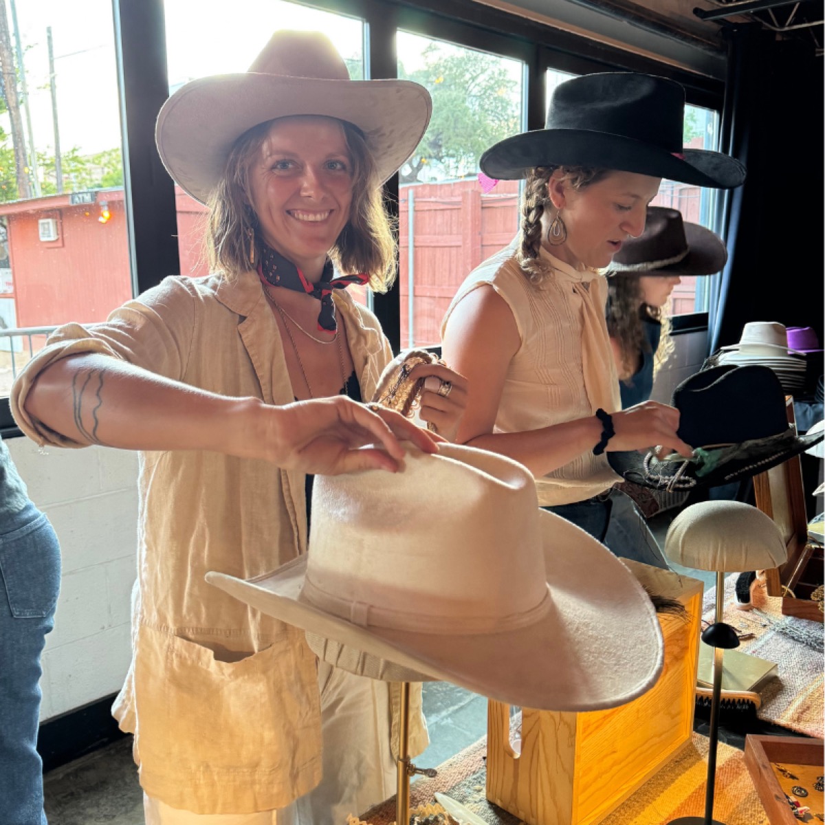 Guest trying on a finished hat at the hat bar