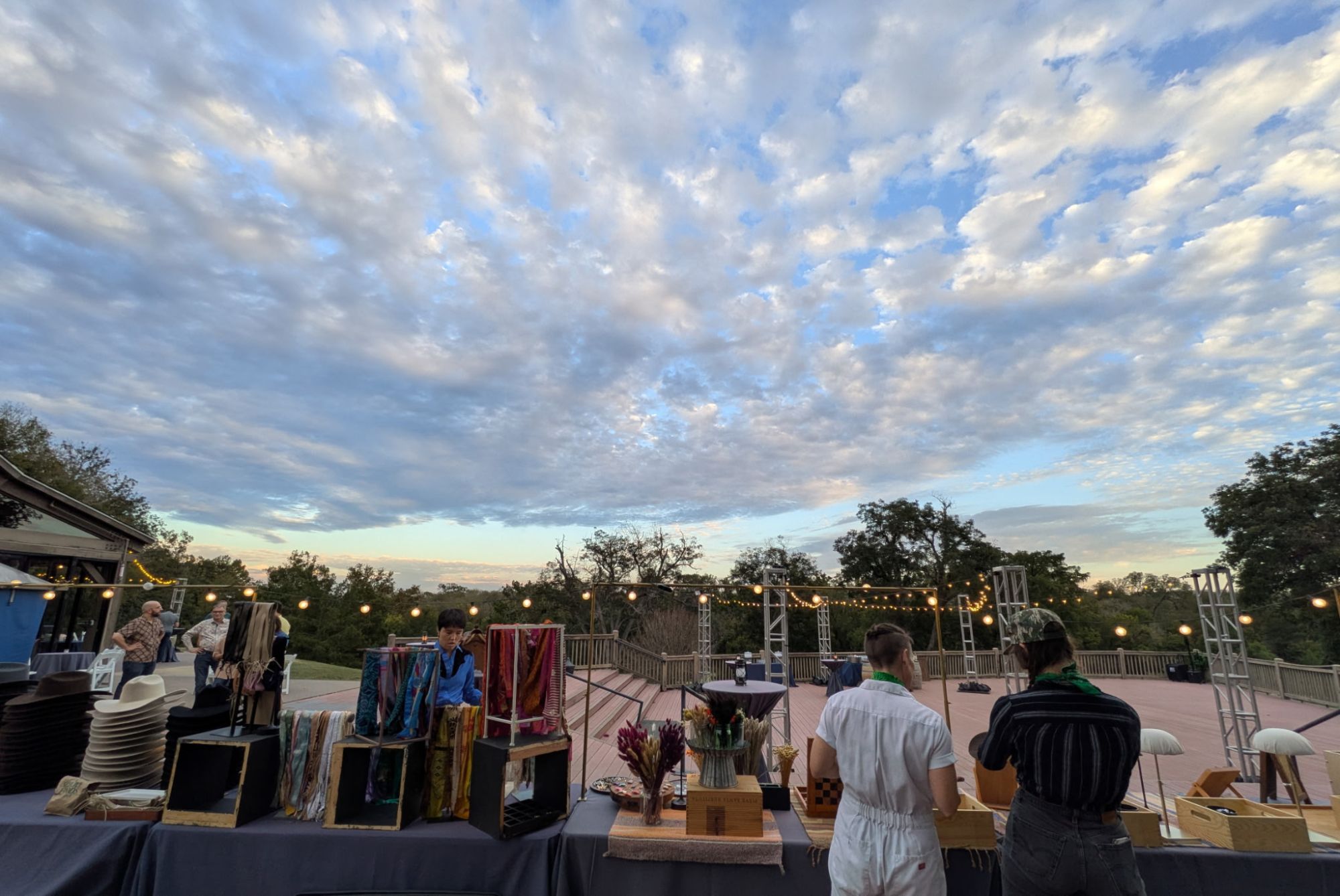 Red's Western hat bar setup at outdoor golden hour event