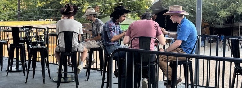 Red's Western hat bar setup at outdoor event Austin Texas