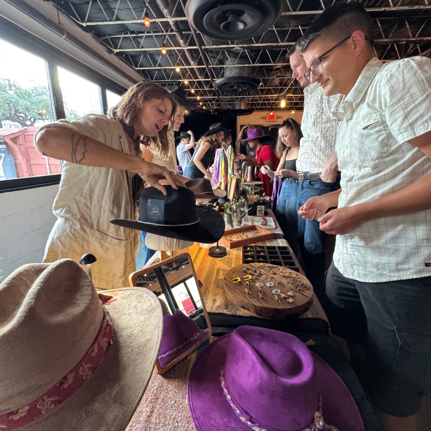 Red's Western stylist showing guests their hat options